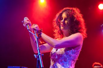 Cantora Céu no palco segurando o microfone